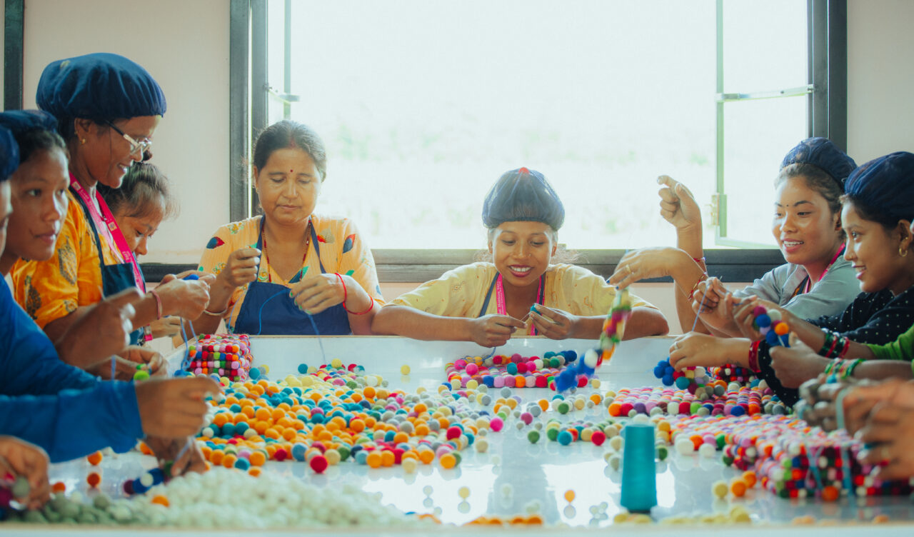 Artisans making handmade wool felt products and colorful felt beads using traditional felting methods